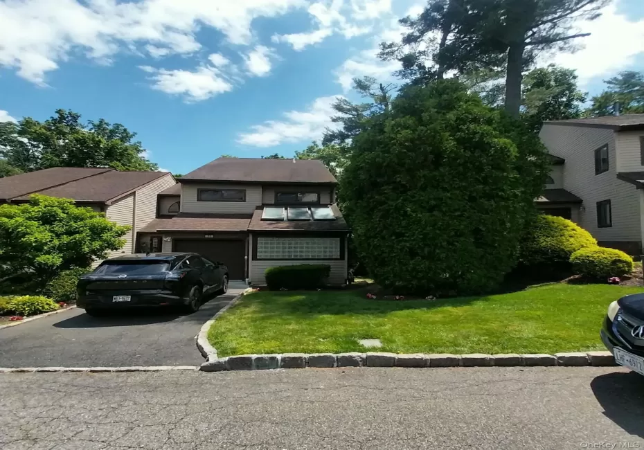 Two-story exterior with a shingle roof and tan siding Two-story exterior with a shingle roof and tan siding