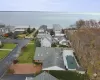 Aerial perspective of suburban area featuring a large body of water Aerial perspective of suburban area featuring a large body of water