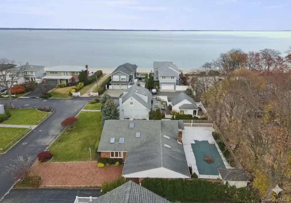 Aerial perspective of suburban area featuring a large body of water Aerial perspective of suburban area featuring a large body of water