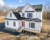 Modern farmhouse featuring a shingled roof and covered porch Modern farmhouse featuring a shingled roof and covered porch