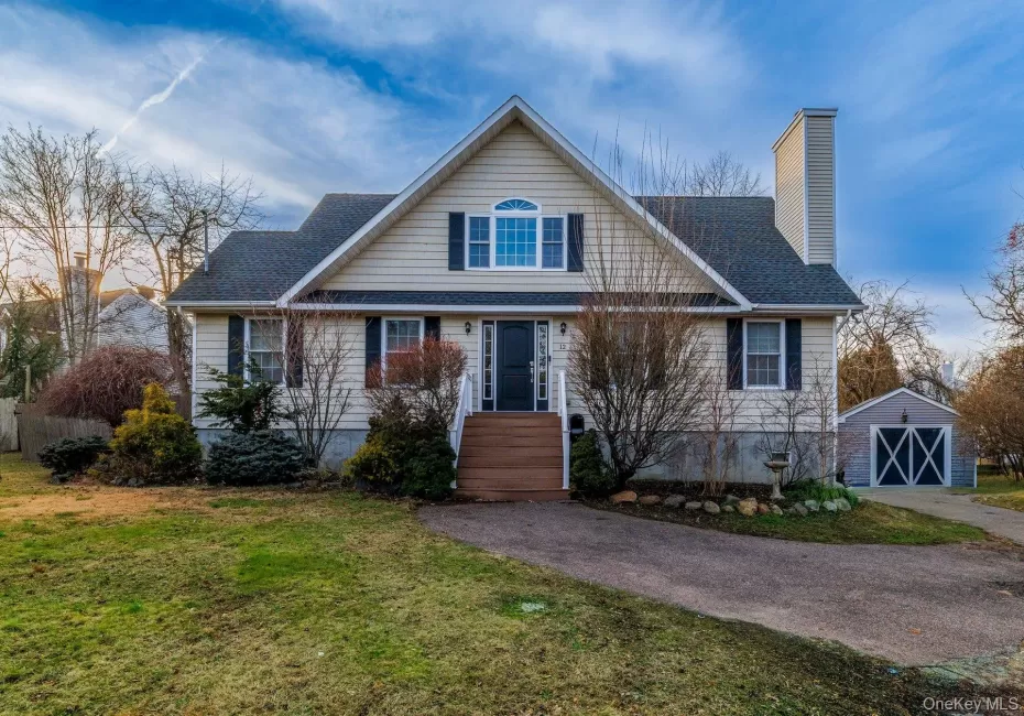 View of front of property with an outdoor structure, a front lawn, a chimney, and roof with shingles View of front of property with an outdoor structure, a front lawn, a chimney, and roof with shingles