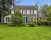 Stone and siding exterior with a vibrant blue entry door Stone and siding exterior with a vibrant blue entry door