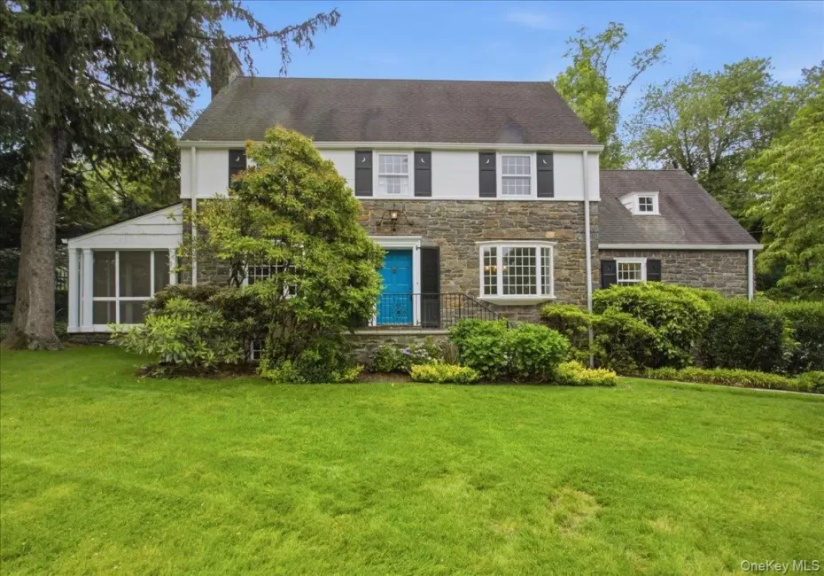 Stone and siding exterior with a vibrant blue entry door Stone and siding exterior with a vibrant blue entry door