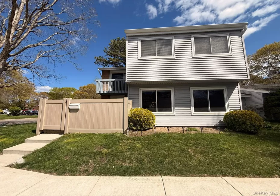 Two-story residence featuring light gray horizontal siding and white trim Two-story residence featuring light gray horizontal siding and white trim