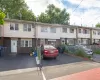 Multi-unit row house featuring two levels, white siding, and a partial brick facade Multi-unit row house featuring two levels, white siding, and a partial brick facade