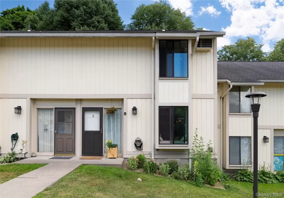 Light-toned vertical siding exterior with contrasting trim details Light-toned vertical siding exterior with contrasting trim details