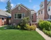 Brick exterior with a gabled roofline, multiple windows, and a paved walkway leading to the entrance Brick exterior with a gabled roofline, multiple windows, and a paved walkway leading to the entrance