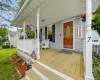 Charming covered front porch with classic curb appeal, white railings, decorative columns, and inviting front entry. Charming covered front porch with classic curb appeal, white railings, decorative columns, and inviting front entry.