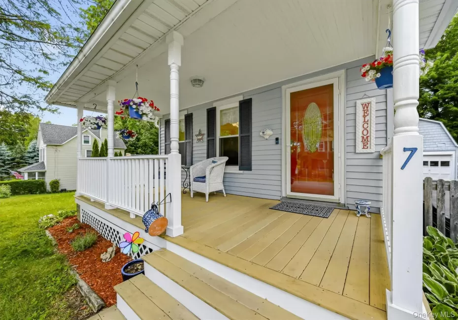 Charming covered front porch with classic curb appeal, white railings, decorative columns, and inviting front entry. Charming covered front porch with classic curb appeal, white railings, decorative columns, and inviting front entry.