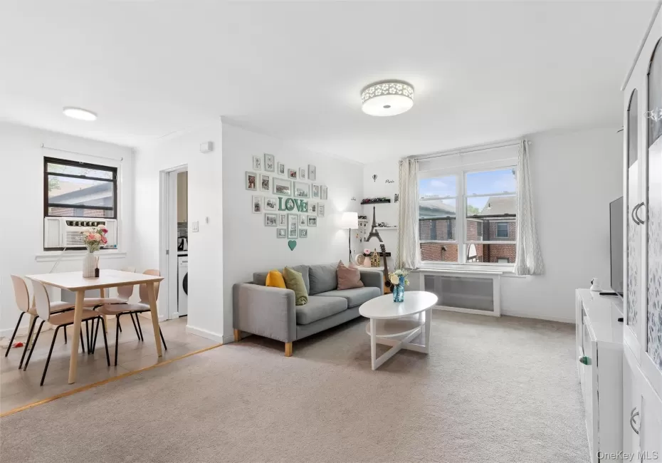 Bright living space featuring neutral carpet flooring and white painted walls Bright living space featuring neutral carpet flooring and white painted walls