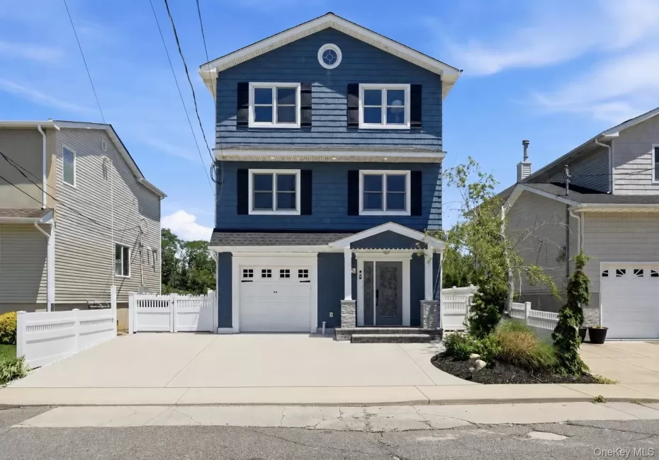 Three-story residence featuring blue siding with white trim and black shutters Three-story residence featuring blue siding with white trim and black shutters