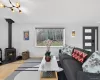 Living area with wood finished floors and a wood stove Living area with wood finished floors and a wood stove