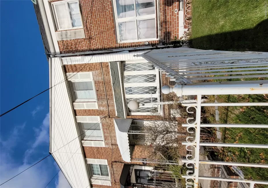 Traditional-style house with a fenced front yard and brick siding Traditional-style house with a fenced front yard and brick siding