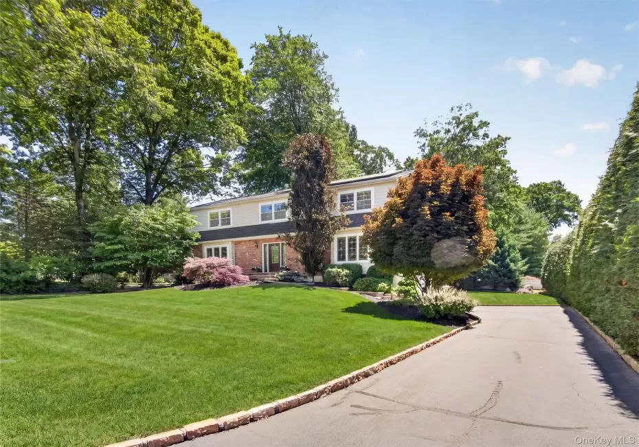 An impressive approach reveals this stately Colonial, nestled among mature trees and meticulous landscaping. An impressive approach reveals this stately Colonial, nestled among mature trees and meticulous landscaping.