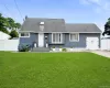 Charming single-story residence featuring blue horizontal siding and a dark shingle roof Charming single-story residence featuring blue horizontal siding and a dark shingle roof
