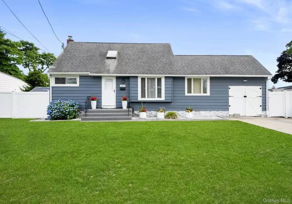 Charming single-story residence featuring blue horizontal siding and a dark shingle roof Charming single-story residence featuring blue horizontal siding and a dark shingle roof