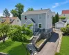 Two-story residence featuring light gray siding and a dark gray roof Two-story residence featuring light gray siding and a dark gray roof