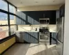 Kitchen featuring sink, light hardwood / wood-style flooring, stainless steel appliances, and a healthy amount of sunlight Kitchen featuring sink, light hardwood / wood-style flooring, stainless steel appliances, and a healthy amount of sunlight