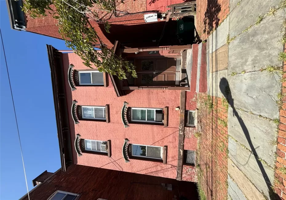 Three-story brick facade property with a covered entry Three-story brick facade property with a covered entry