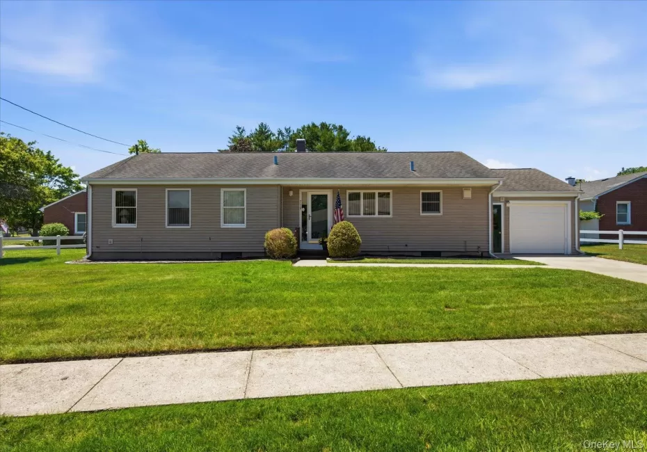 Front of home with Cement Driveway and Sidewalk lined street Front of home with Cement Driveway and Sidewalk lined street