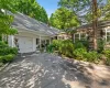 Charming exterior with cedar shake siding, a covered entry porch, and an attached garage Charming exterior with cedar shake siding, a covered entry porch, and an attached garage