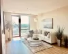 Living room featuring light wood finished floors and floor to ceiling windows Living room featuring light wood finished floors and floor to ceiling windows