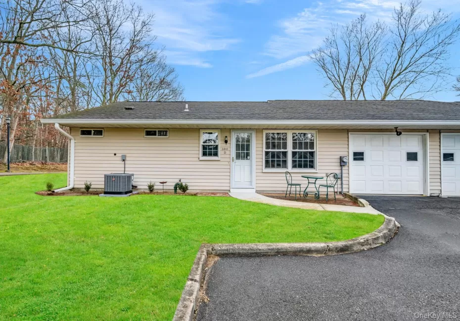 Rear view of house featuring driveway, an attached garage, a yard, and a shingled roof Rear view of house featuring driveway, an attached garage, a yard, and a shingled roof