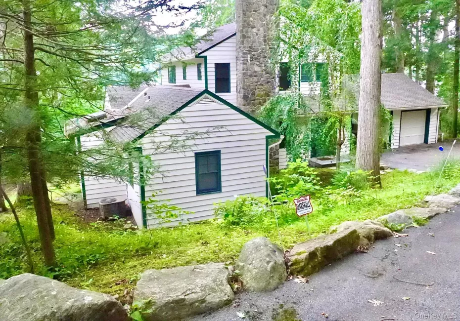 The home has two private bedrooms downstairs, and two up, with an open-plan kitchen, dining, and living area with views of the lake. The home has two private bedrooms downstairs, and two up, with an open-plan kitchen, dining, and living area with views of the lake.