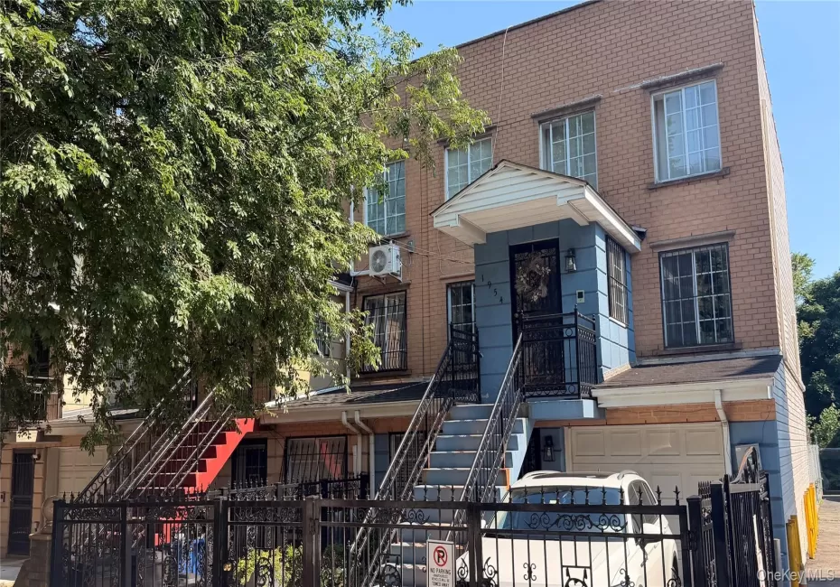 Two-story brick facade property featuring a prominent entry porch with a protective overhang Two-story brick facade property featuring a prominent entry porch with a protective overhang