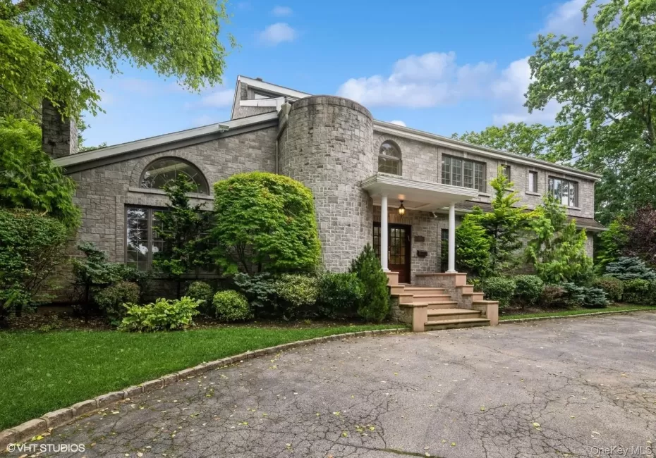 Front of property featuring a chimney Front of property featuring a chimney