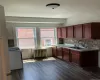Kitchen featuring dark wood-finish flooring, white walls, and a ceiling-mounted light fixture Kitchen featuring dark wood-finish flooring, white walls, and a ceiling-mounted light fixture