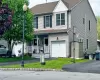 View of front of property with covered porch, a garage, driveway, a front yard, and roof with shingles View of front of property with covered porch, a garage, driveway, a front yard, and roof with shingles