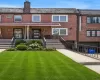 Brick facade home featuring a covered front porch, concrete front steps with metal railings, and a concrete driveway Brick facade home featuring a covered front porch, concrete front steps with metal railings, and a concrete driveway