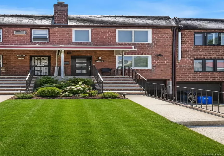 Brick facade home featuring a covered front porch, concrete front steps with metal railings, and a concrete driveway Brick facade home featuring a covered front porch, concrete front steps with metal railings, and a concrete driveway