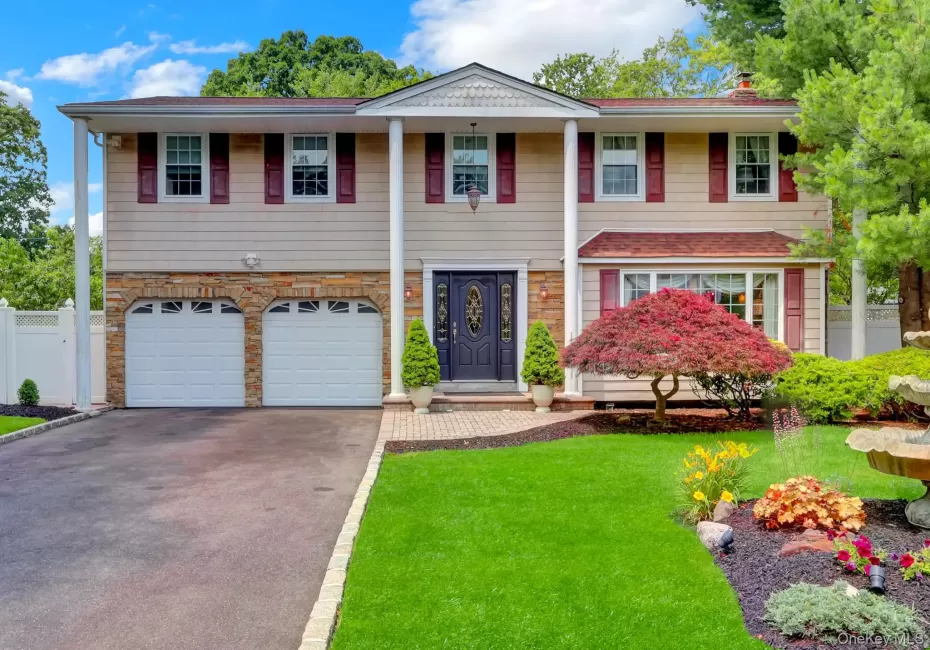 Large Colonial residence featuring a prominent front entrance with an ornate dark wood door Large Colonial residence featuring a prominent front entrance with an ornate dark wood door