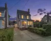 Two-story residence featuring light-toned siding and multiple windows Two-story residence featuring light-toned siding and multiple windows