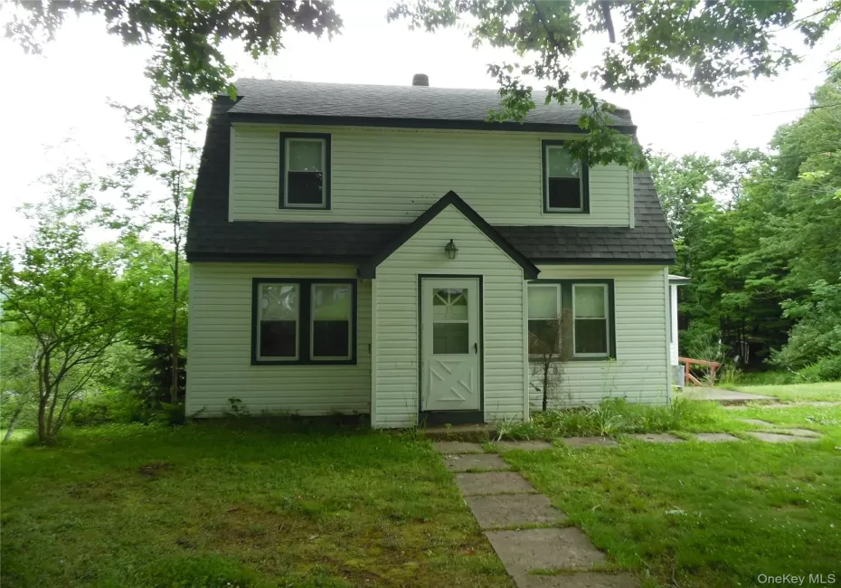 Two-story residence featuring white siding and a dark roof Two-story residence featuring white siding and a dark roof