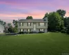 Bi-level residence featuring a light-toned exterior with dark shutters and a central entry Bi-level residence featuring a light-toned exterior with dark shutters and a central entry