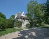Two-story residence featuring a gray shingle exterior and white trim Two-story residence featuring a gray shingle exterior and white trim