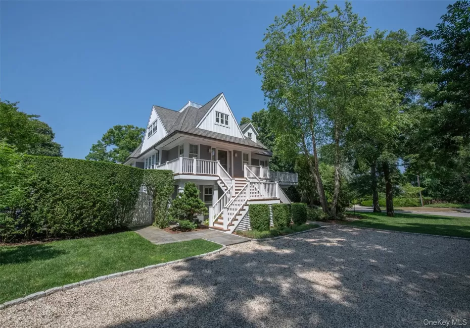 Two-story residence featuring a gray shingle exterior and white trim Two-story residence featuring a gray shingle exterior and white trim