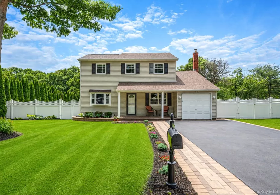 Stunning Colonial featuring a covered front porch with recessed lighting, oversized driveway; attached one car garage. Stunning Colonial featuring a covered front porch with recessed lighting, oversized driveway; attached one car garage.