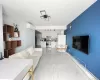 Living area with a baseboard radiator, light marble finish floors, and a wall mounted AC Living area with a baseboard radiator, light marble finish floors, and a wall mounted AC