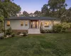 Ranch-style residence featuring white siding and a dark shingle roof Ranch-style residence featuring white siding and a dark shingle roof