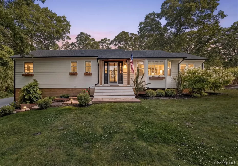 Ranch-style residence featuring white siding and a dark shingle roof Ranch-style residence featuring white siding and a dark shingle roof