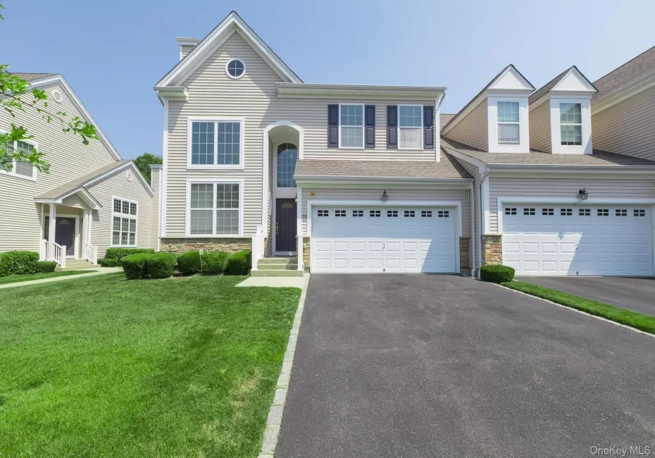 Light-toned siding exterior with stone accenting Light-toned siding exterior with stone accenting