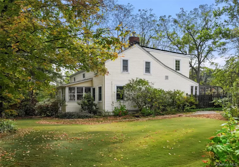 View of property exterior featuring an enclosed front porch View of property exterior featuring an enclosed front porch