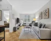Living room featuring pristine parquet floors and radiator Living room featuring pristine parquet floors and radiator