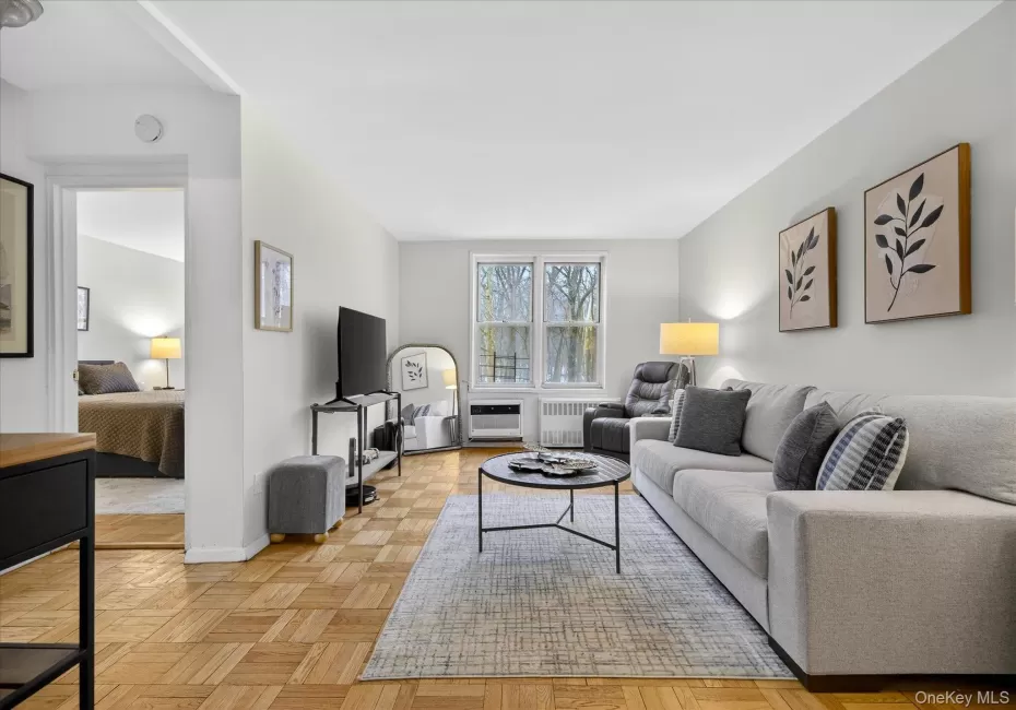 Living room featuring pristine parquet floors and radiator Living room featuring pristine parquet floors and radiator