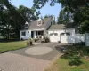 White siding residence featuring a two-car garage with arched panel doors and overhead lighting. Architectural Driveway. White siding residence featuring a two-car garage with arched panel doors and overhead lighting. Architectural Driveway.