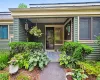 Front covered entry porch with beautiful plantings. Front covered entry porch with beautiful plantings.